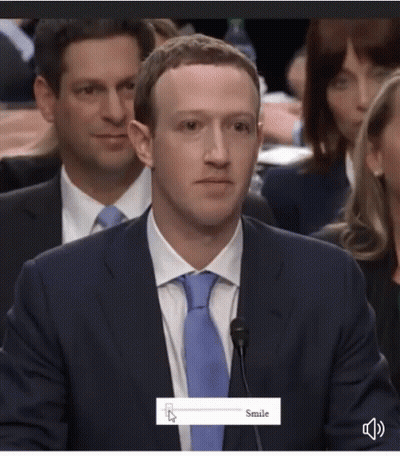 A Man In A Suit And Tie Is Smiling While Sitting At A Microphone GIF