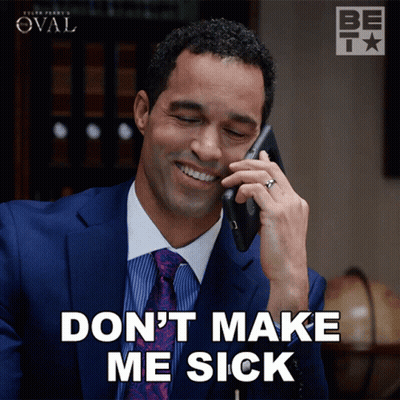 A Man In A Suit And Tie Is Smiling While Talking On A Cell Phone GIF
