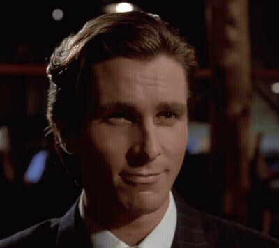 A Man In A Suit And Tie Is Smiling With His Eyes Closed GIF