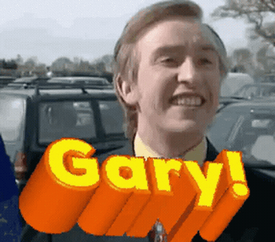 A Man In A Suit And Tie Is Smiling With The Word Gary Above Him GIF