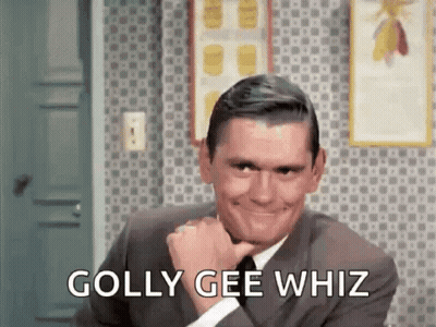 A Man In A Suit And Tie Is Smiling With The Words `` Golly Gee Whiz '' Written Next To Him . GIF