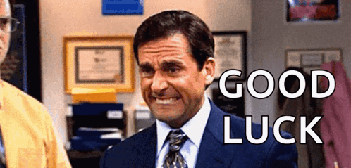 A Man In A Suit And Tie Is Smiling With The Words `` Good Luck '' Behind Him . GIF