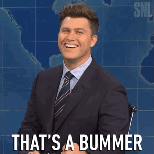 A Man In A Suit And Tie Is Smiling With The Words That 'S A Bummer Behind Him GIF