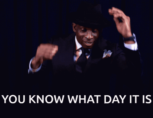 A Man In A Suit And Tie Is Smiling With The Words " You Know What Day It Is " Below Him GIF