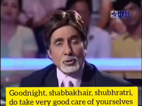 A Man In A Suit And Tie Is Speaking In Front Of A Crowd GIF