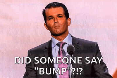 A Man In A Suit And Tie Is Speaking Into A Microphone And Says Did Someone Say " Bump " GIF