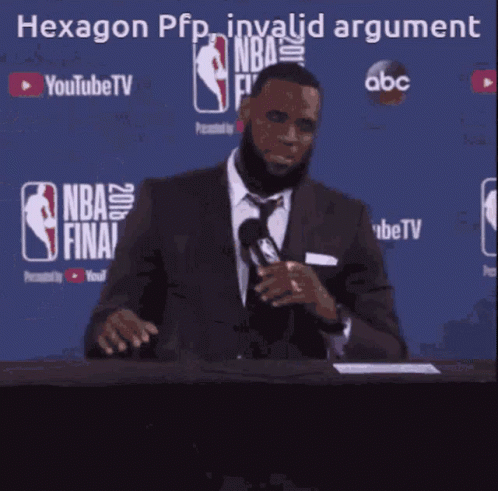 A Man In A Suit And Tie Is Speaking Into A Microphone In Front Of A Blue Background That Says Nba Finals GIF