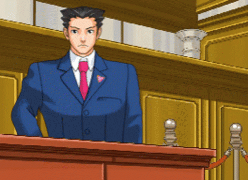 A Man In A Suit And Tie Is Standing Behind A Podium GIF