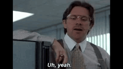 A Man In A Suit And Tie Is Standing In A Cubicle And Saying Uh , Yeah . GIF
