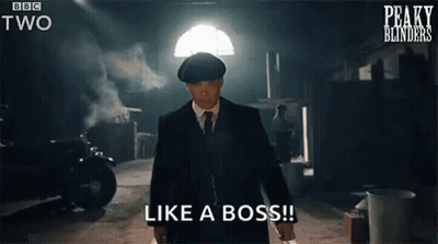 A Man In A Suit And Tie Is Standing In A Dark Room Holding A Knife And Says `` Like A Boss '' . GIF