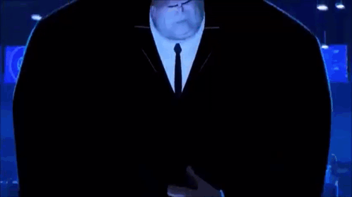 A Man In A Suit And Tie Is Standing In A Dark Room With A Globe In The Background . GIF