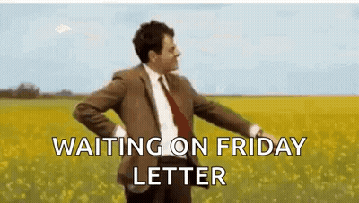 A Man In A Suit And Tie Is Standing In A Field Of Flowers . GIF