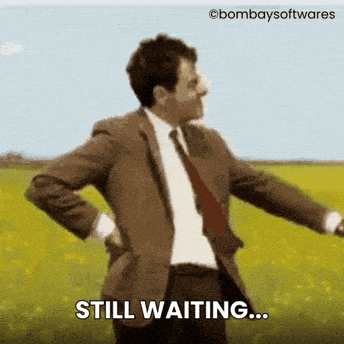A Man In A Suit And Tie Is Standing In A Field With The Words Still Waiting Below Him GIF