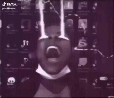 A Man In A Suit And Tie Is Standing In A Foggy Room With A Lightning Bolt Behind Him . GIF
