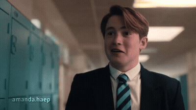 A Man In A Suit And Tie Is Standing In A Hallway With Amanda.haep Written On The Bottom Right GIF