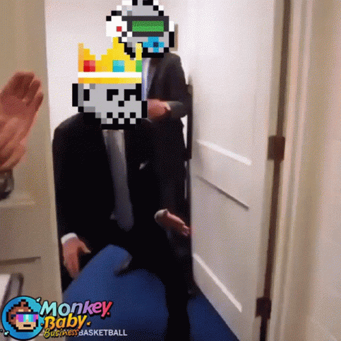 A Man In A Suit And Tie Is Standing In A Hallway With Monkey Baby Basketball Written On The Bottom GIF