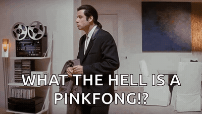 A Man In A Suit And Tie Is Standing In A Living Room With The Words What The Hell Is A Pinkfong .. GIF