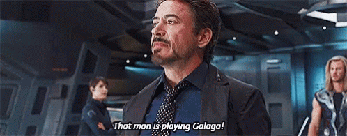 A Man In A Suit And Tie Is Standing In A Room And Talking To Another Man . GIF