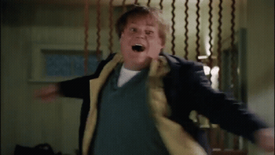 A Man In A Suit And Tie Is Standing In A Room With A Fence In The Background . GIF