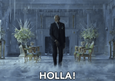 A Man In A Suit And Tie Is Standing In A Room With Holla Written On The Floor GIF