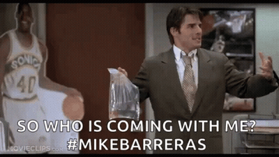 A Man In A Suit And Tie Is Standing In Front Of A Basketball Player Holding A Bag Of Food . GIF