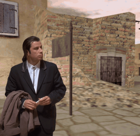 A Man In A Suit And Tie Is Standing In Front Of A Building GIF