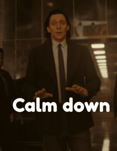 A Man In A Suit And Tie Is Standing In Front Of A Calm Down Sign GIF