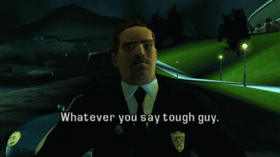 A Man In A Suit And Tie Is Standing In Front Of A Car And Says " Whatever You Say Tough Guy " GIF