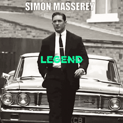 A Man In A Suit And Tie Is Standing In Front Of A Car With The Word Legend Written On It GIF