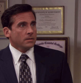 A Man In A Suit And Tie Is Standing In Front Of A Certificate Of Achievement GIF