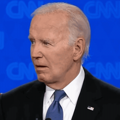 A Man In A Suit And Tie Is Standing In Front Of A Cnn Background GIF