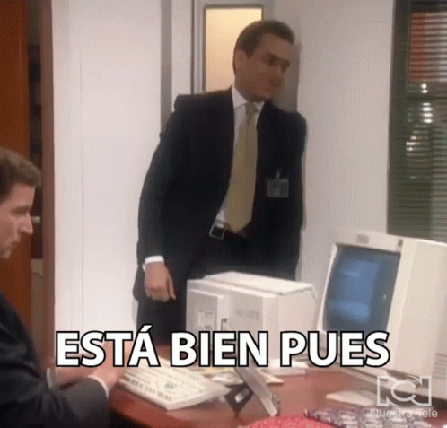 A Man In A Suit And Tie Is Standing In Front Of A Computer With The Words Esta Bien Pues Above Him GIF