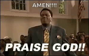 A Man In A Suit And Tie Is Standing In Front Of A Crowd And Saying Amen !!! Praise God ! GIF