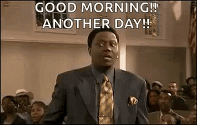 A Man In A Suit And Tie Is Standing In Front Of A Crowd And Saying `` Good Morning ! '' GIF