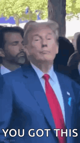 A Man In A Suit And Tie Is Standing In Front Of A Crowd And Saying `` You Got This '' . GIF