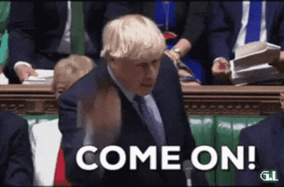 A Man In A Suit And Tie Is Standing In Front Of A Crowd And Says Come On GIF