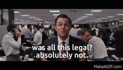 A Man In A Suit And Tie Is Standing In Front Of A Crowd Of People . GIF