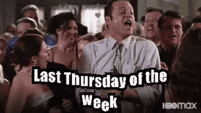 A Man In A Suit And Tie Is Standing In Front Of A Crowd Of People And Screaming . GIF