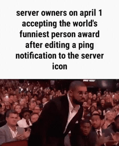 A Man In A Suit And Tie Is Standing In Front Of A Crowd Of People . GIF