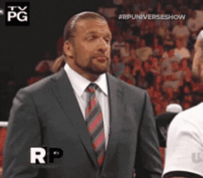 A Man In A Suit And Tie Is Standing In Front Of A Crowd With The Letters Rp On The Bottom GIF