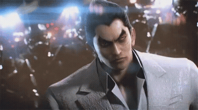 A Man In A Suit And Tie Is Standing In Front Of A Crowd . GIF