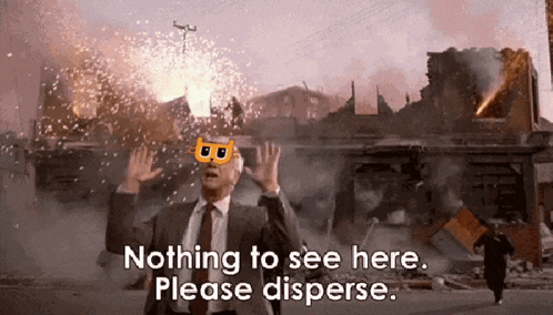 A Man In A Suit And Tie Is Standing In Front Of A Destroyed Building With The Words Nothing To See Here Please Disperse GIF