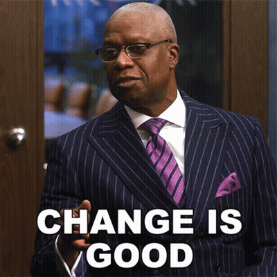 A Man In A Suit And Tie Is Standing In Front Of A Door That Says Change Is Good GIF