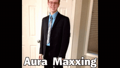 A Man In A Suit And Tie Is Standing In Front Of A Door With Aura Maxxing Written On The Bottom GIF