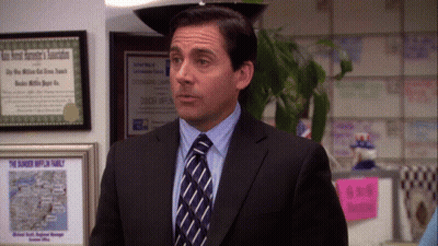 A Man In A Suit And Tie Is Standing In Front Of A Framed Certificate That Says " The Dunkey Hufflin Family " GIF
