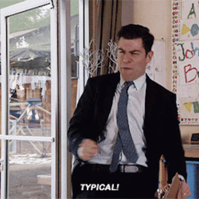A Man In A Suit And Tie Is Standing In Front Of A Glass Door And Says Typical GIF