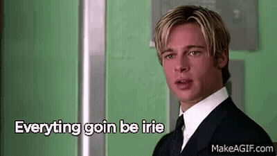 a man in a suit and tie is standing in front of a green wall with the words `` everything goin be irie '' .