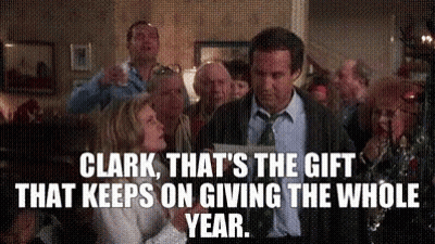 A Man In A Suit And Tie Is Standing In Front Of A Group Of People . GIF