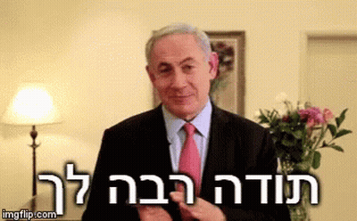 A Man In A Suit And Tie Is Standing In Front Of A Lamp And Flowers With The Words " Imgflip.com " Above Him GIF