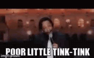 A Man In A Suit And Tie Is Standing In Front Of A Microphone . GIF